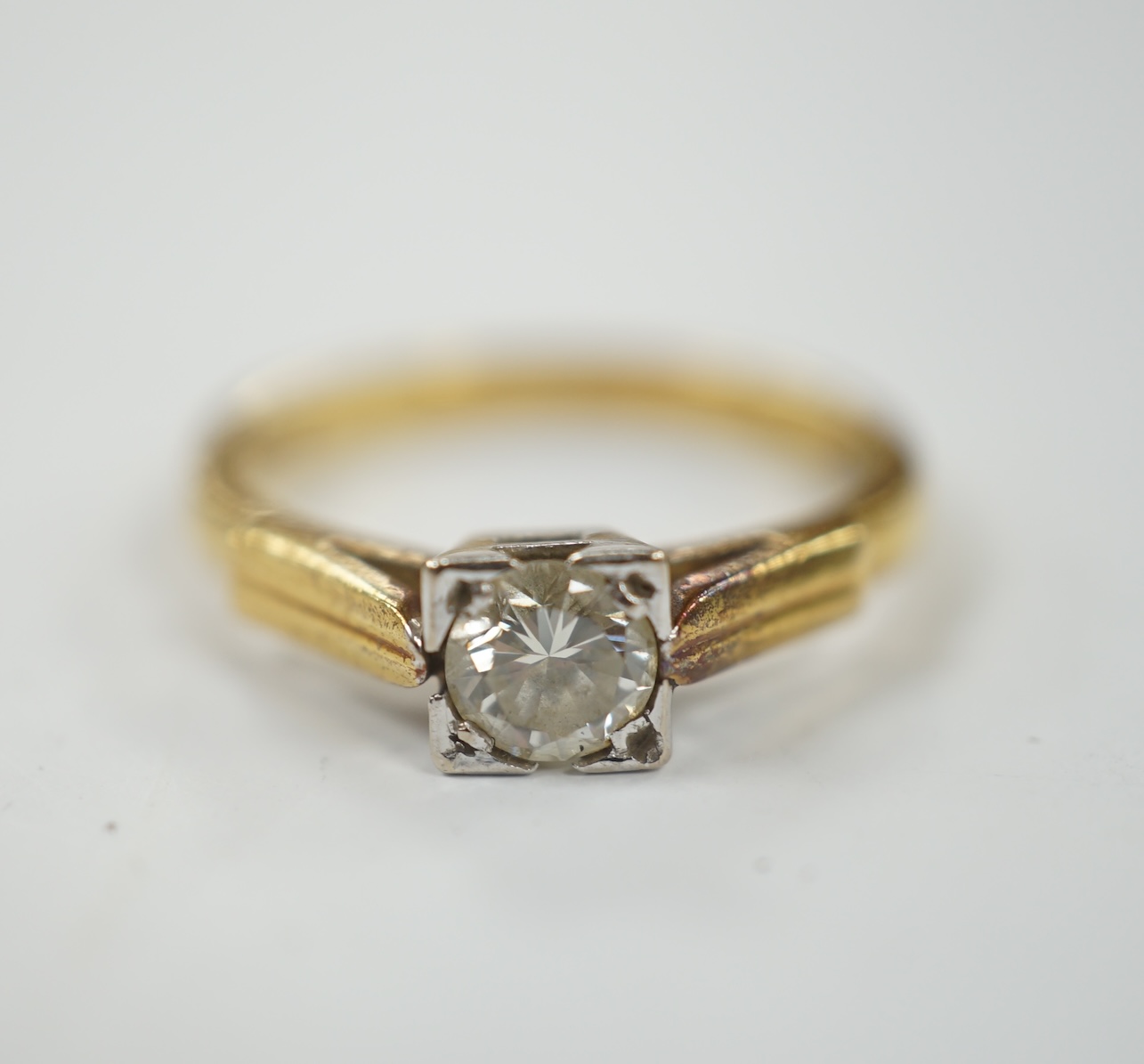 A modern 18ct gold and solitaire diamond set ring, size N, gross weight 3.6 grams.